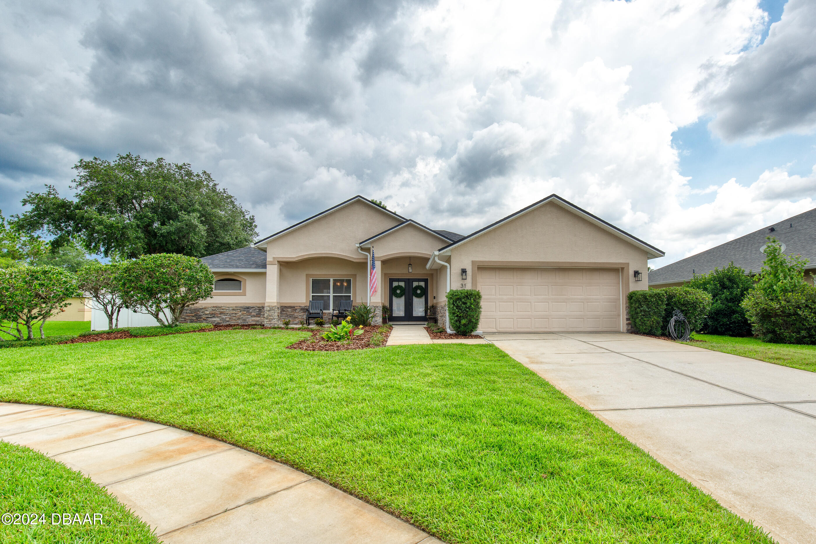 a front view of house with yard and green space