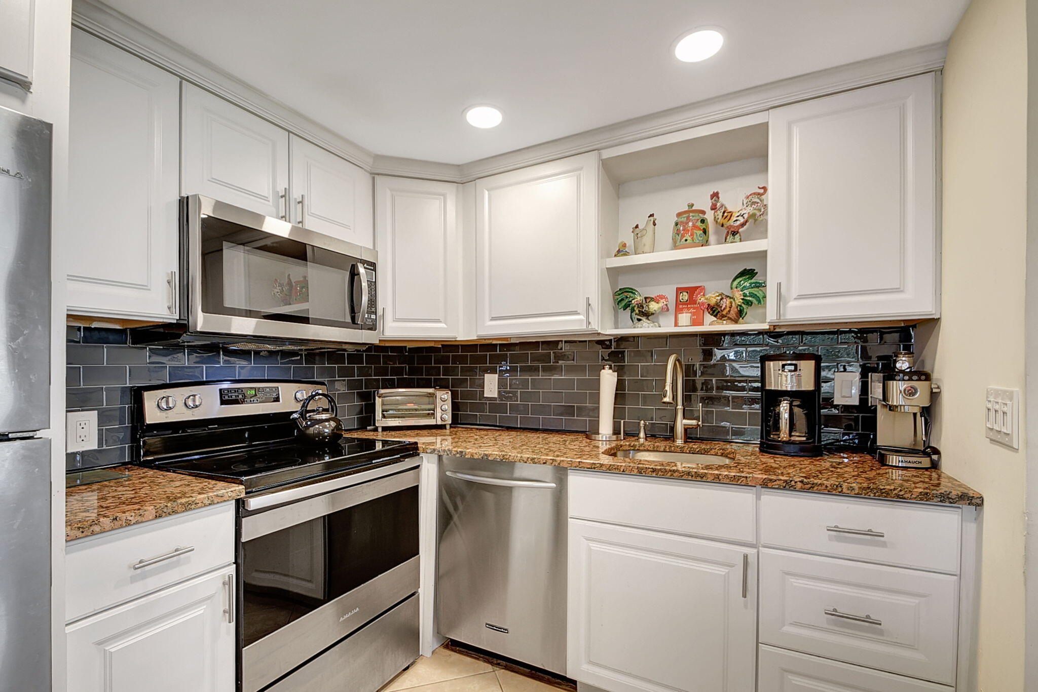 a kitchen with appliances a sink and cabinets