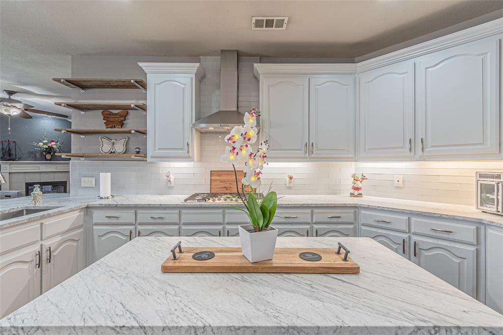 a kitchen with kitchen island granite countertop sink and dishwasher