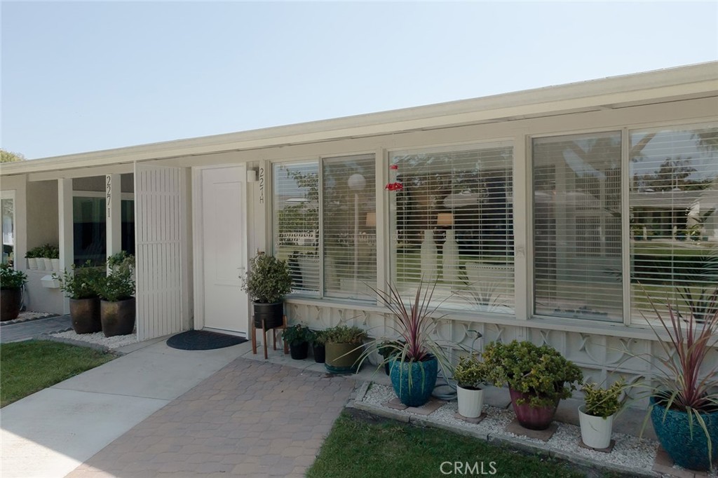 a front view of a house with plants