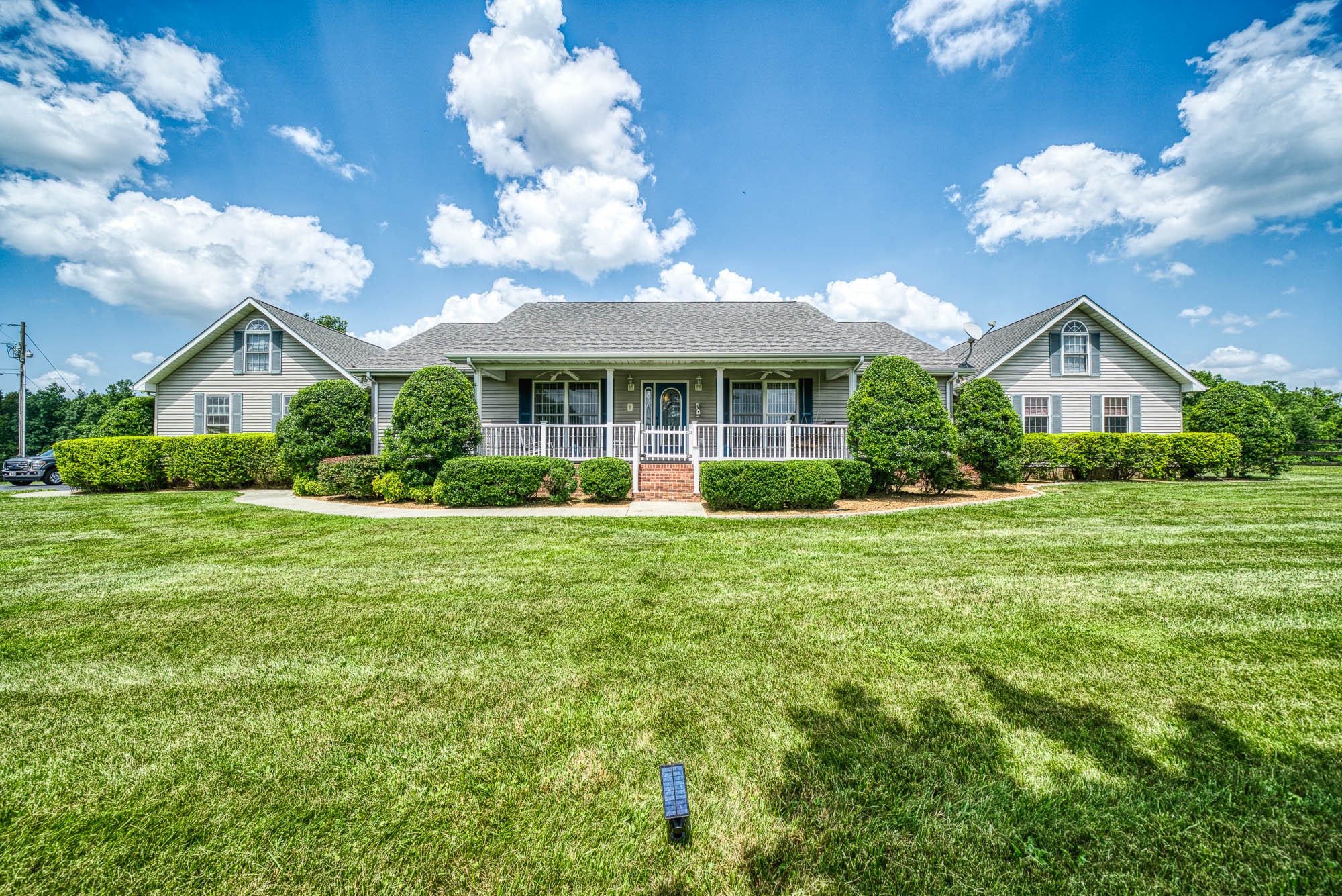 a front view of a house with garden