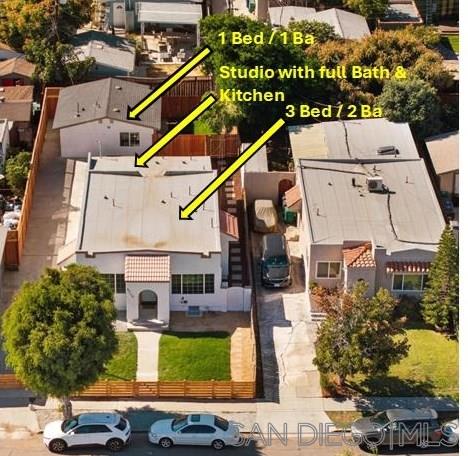 a aerial view of a house with a yard and potted plants