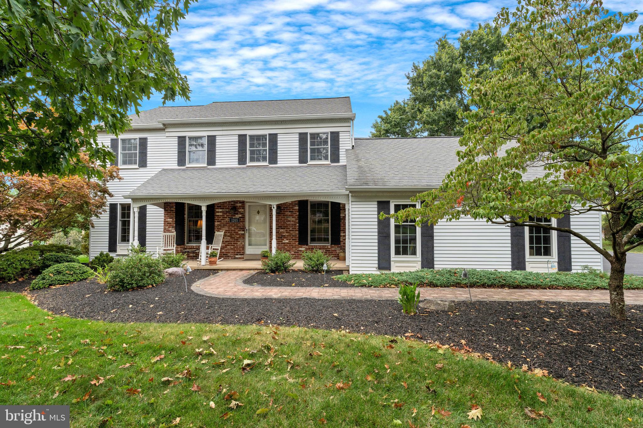 a front view of a house with garden and porch