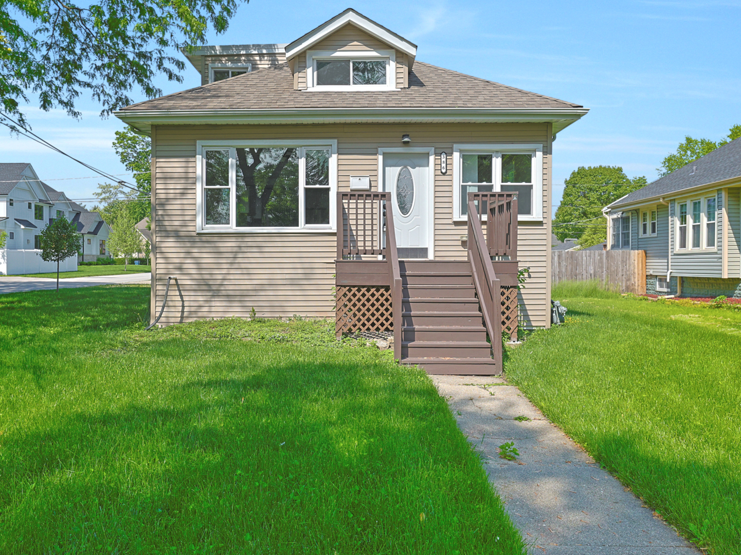 a front view of a house with a garden