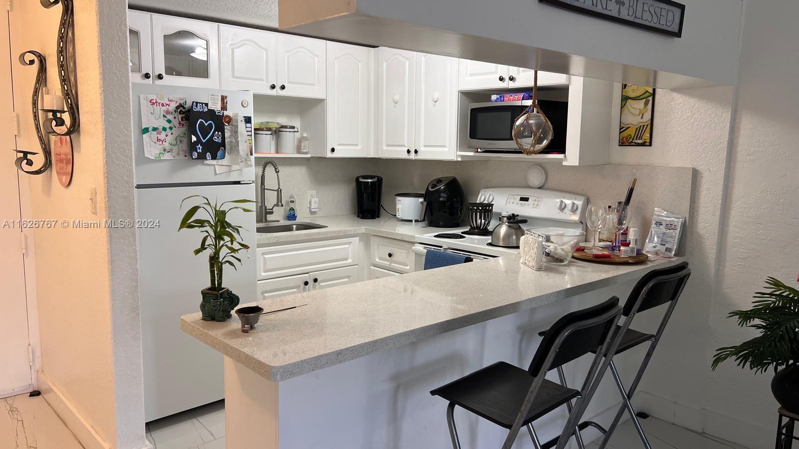 a kitchen with a sink cabinets and black appliances