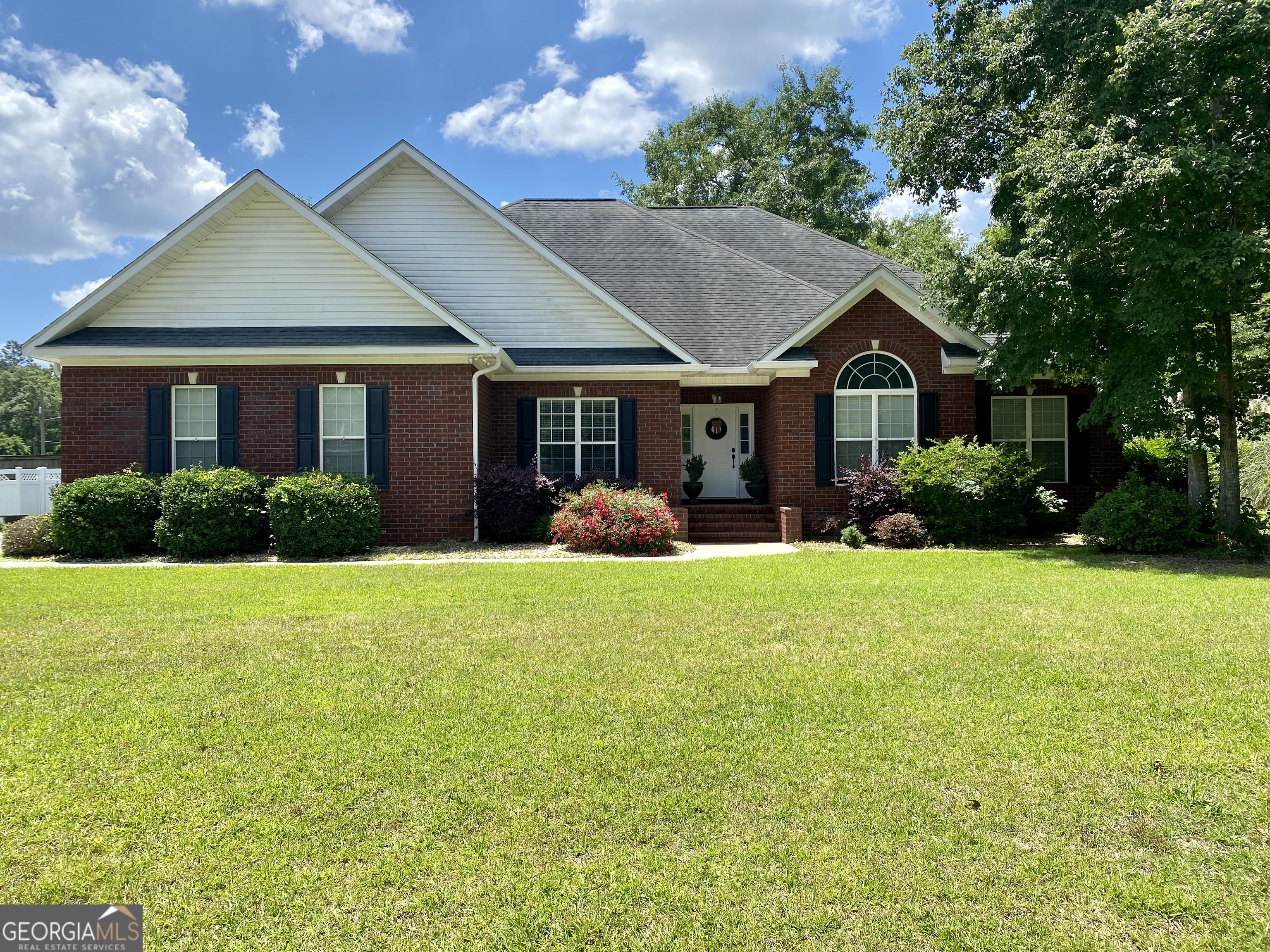 a front view of a house with garden