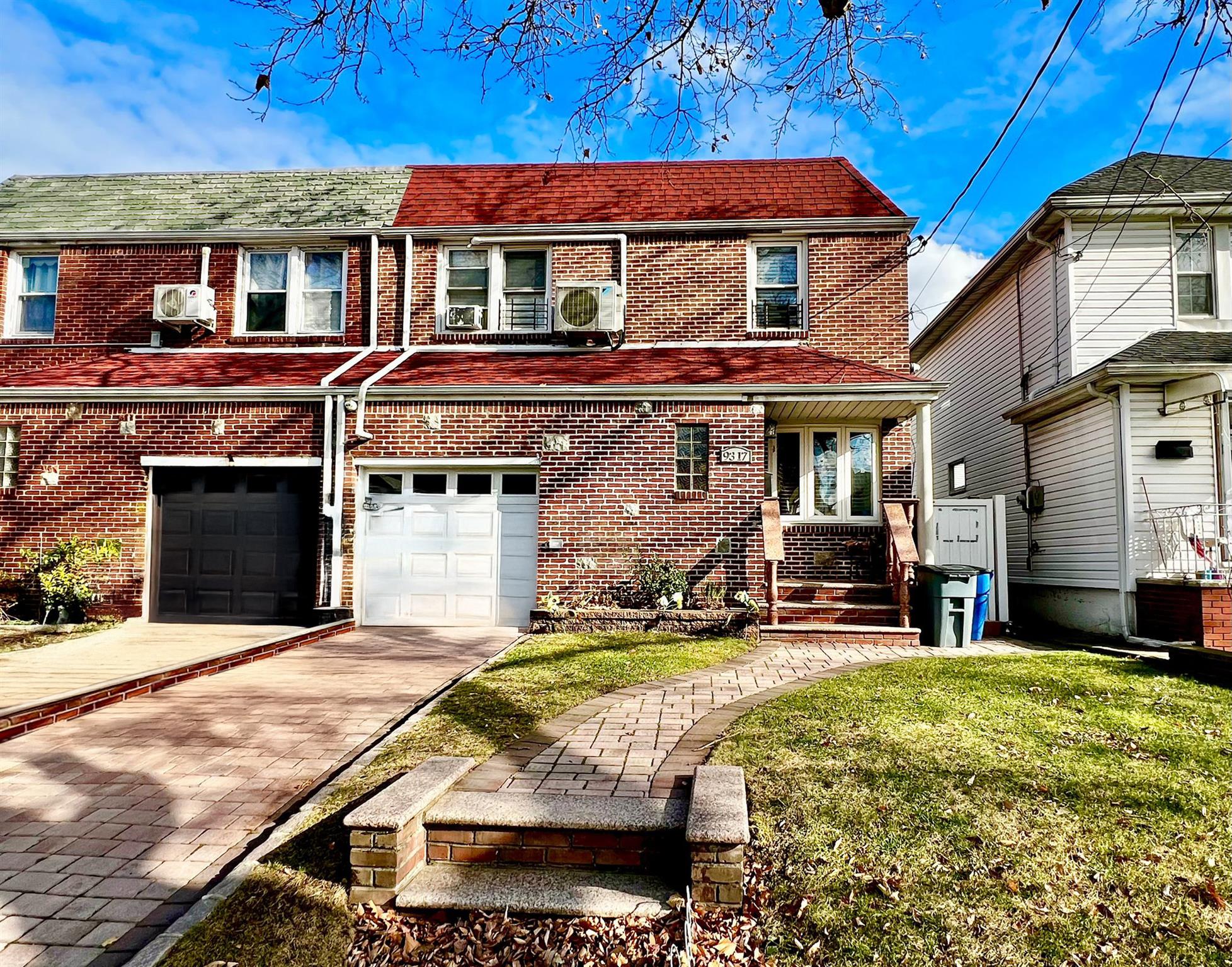 View of front of home featuring a front yard and a garage