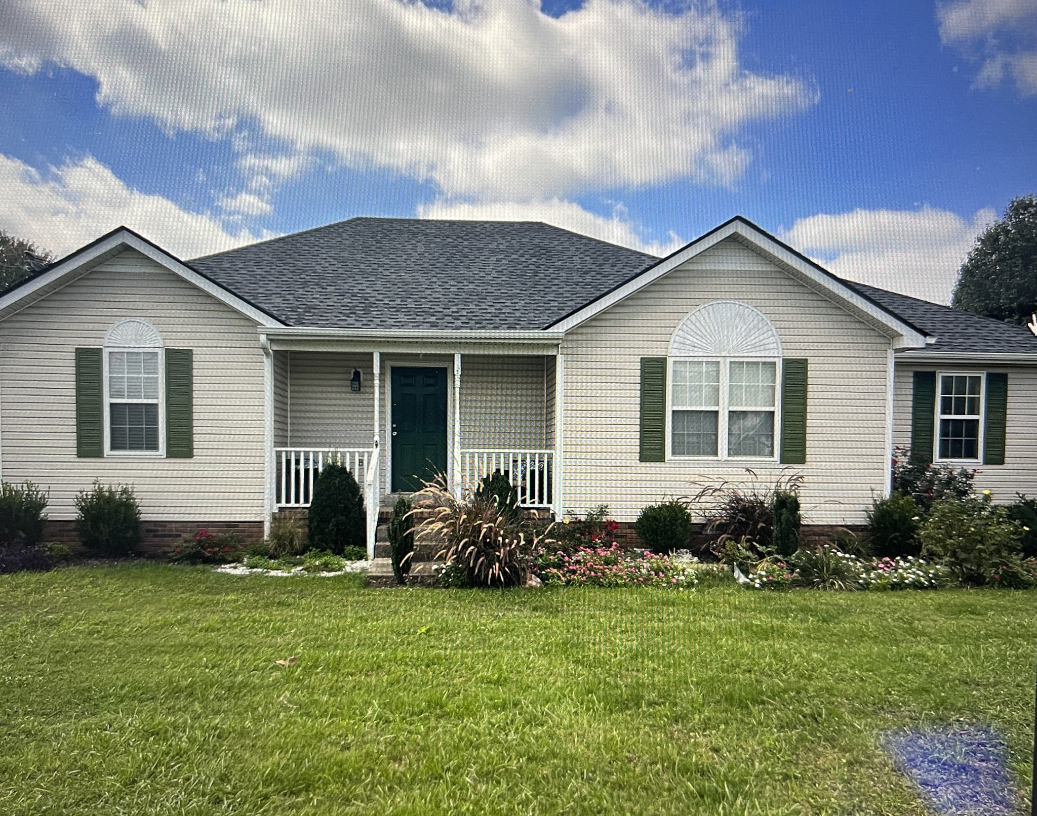 a view of a house with a yard and plants