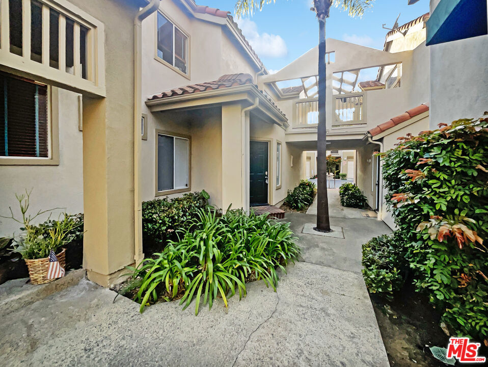 a view of a house with potted plants