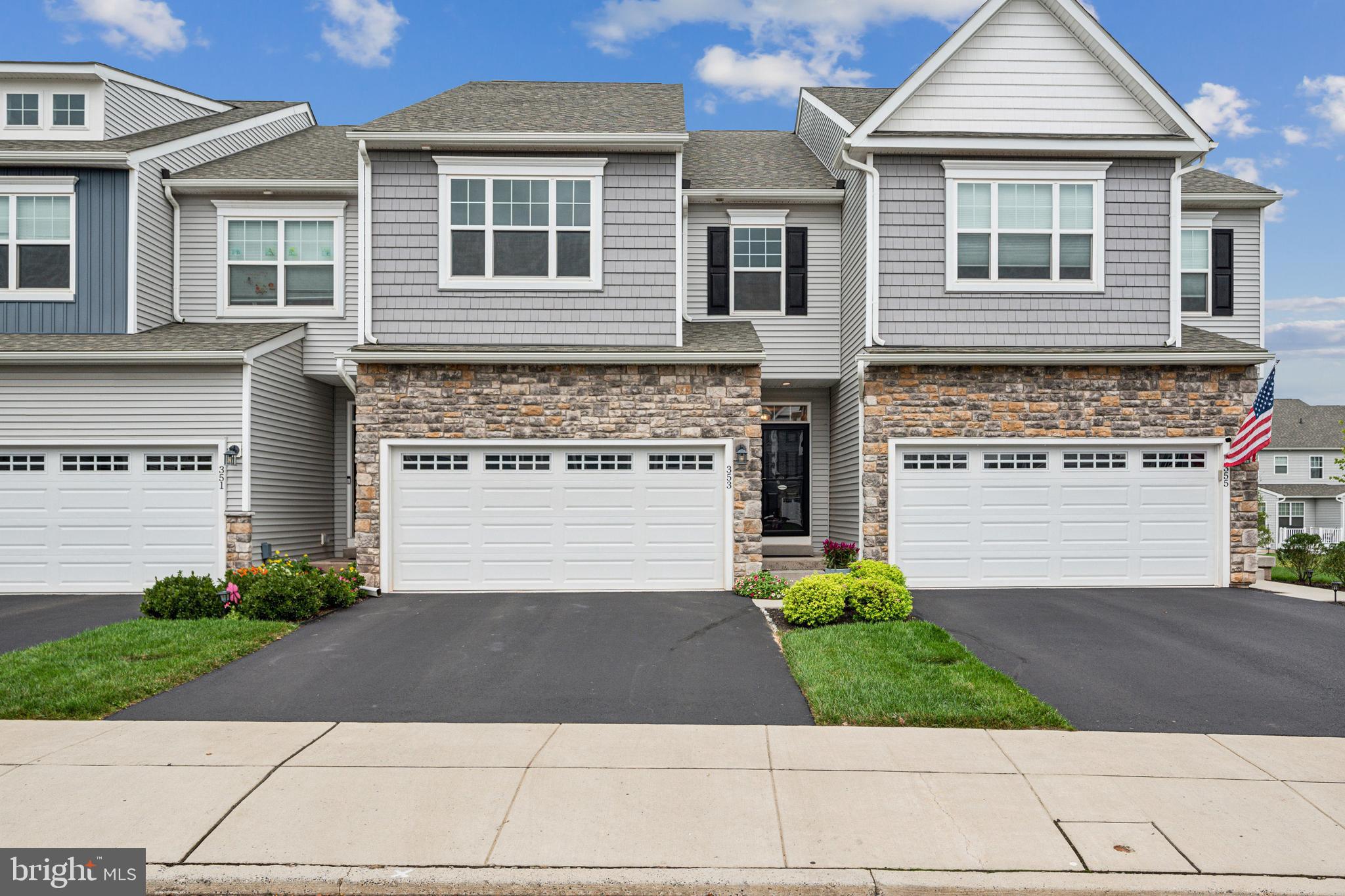 a front view of a house with a garden and garage