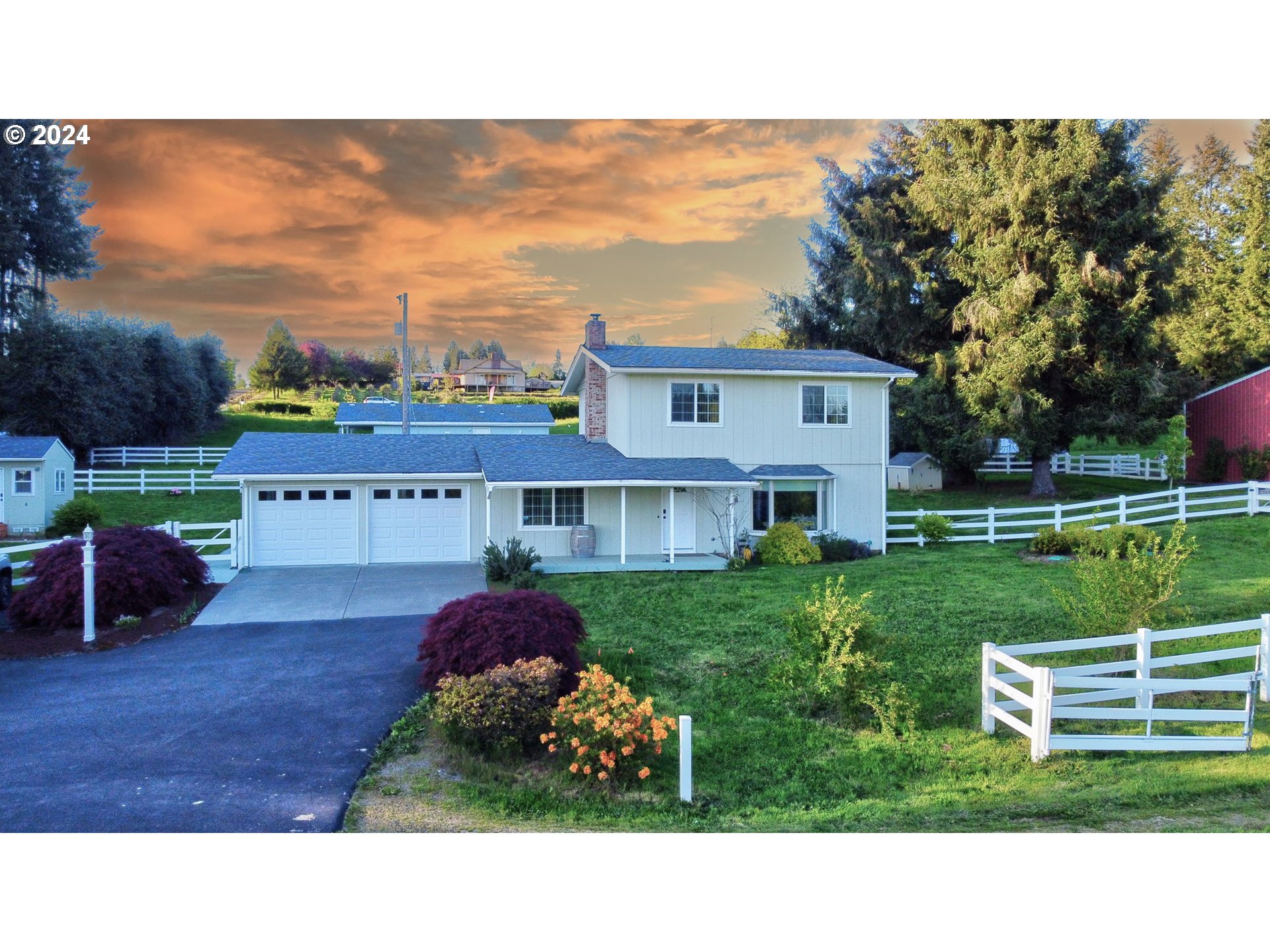 a view of a house with a backyard and a garden