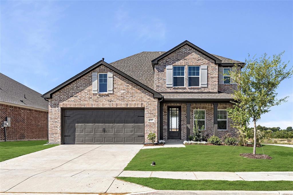 a front view of a house with a yard and garage