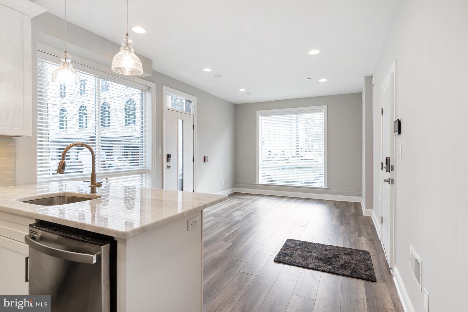 a view of kitchen with sink and wooden floor