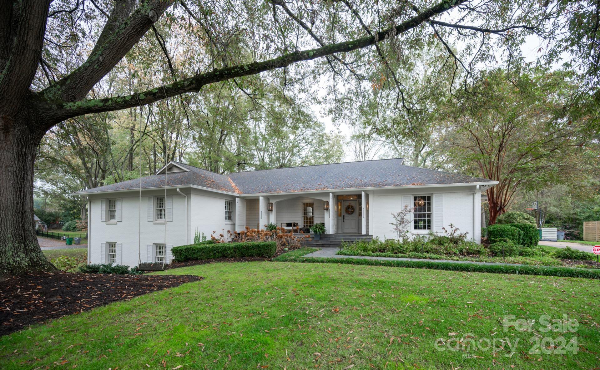 a front view of house with yard and green space