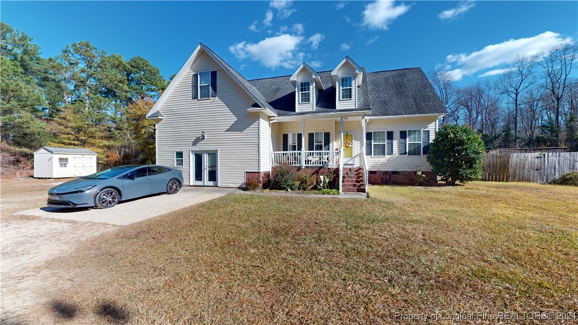 a front view of a house with a yard and outdoor seating