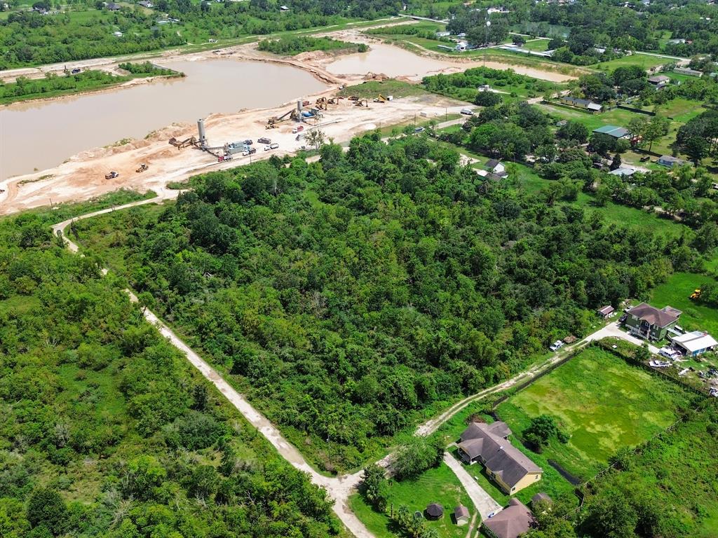 an aerial view of residential houses with outdoor space and trees