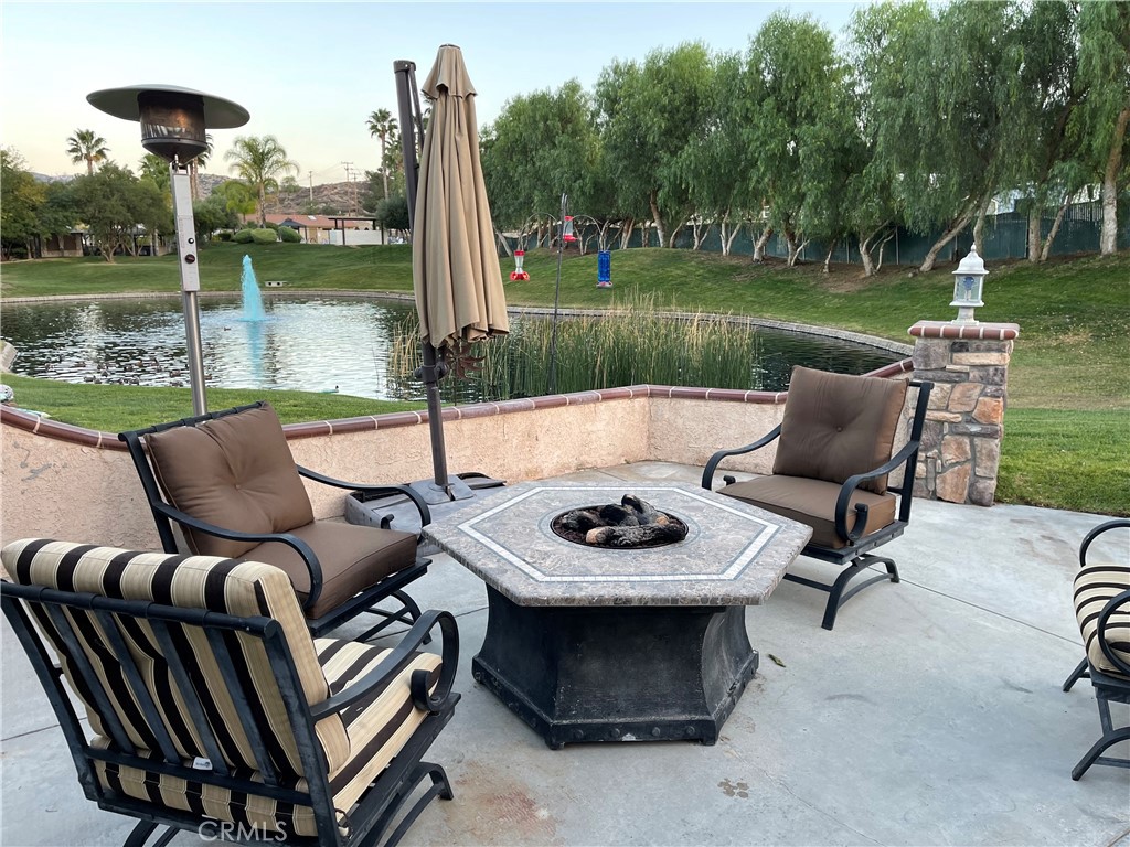 a view of a patio with furniture and a yard