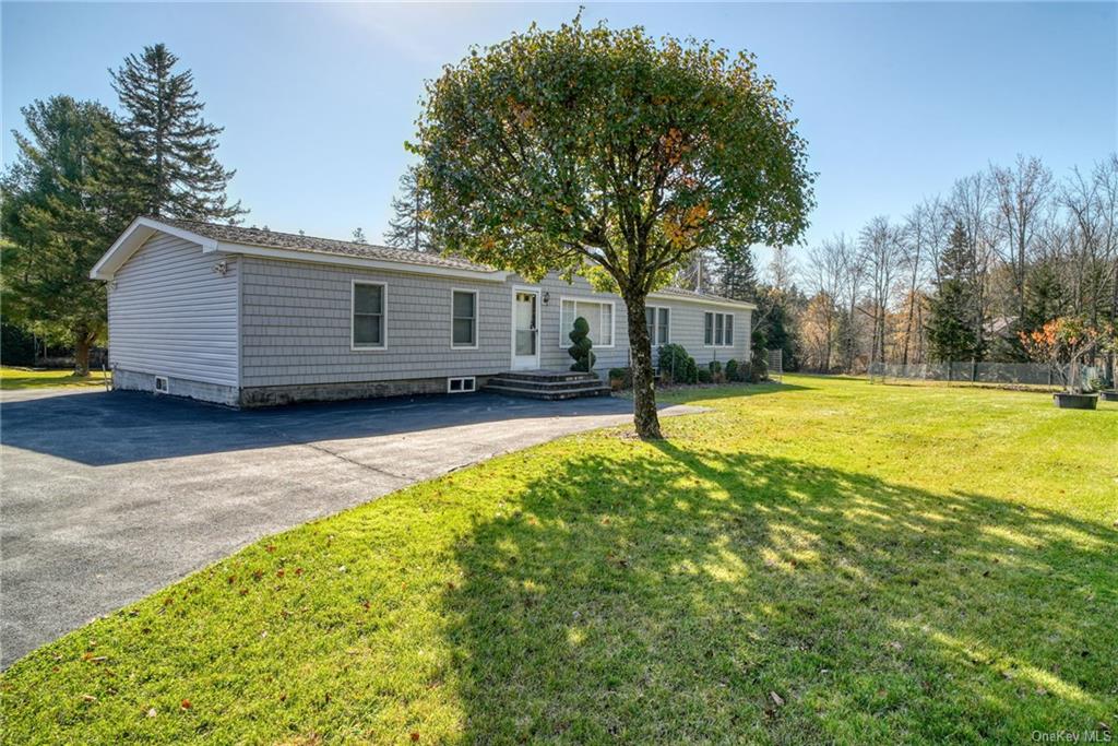 a view of a house with a yard and tree s