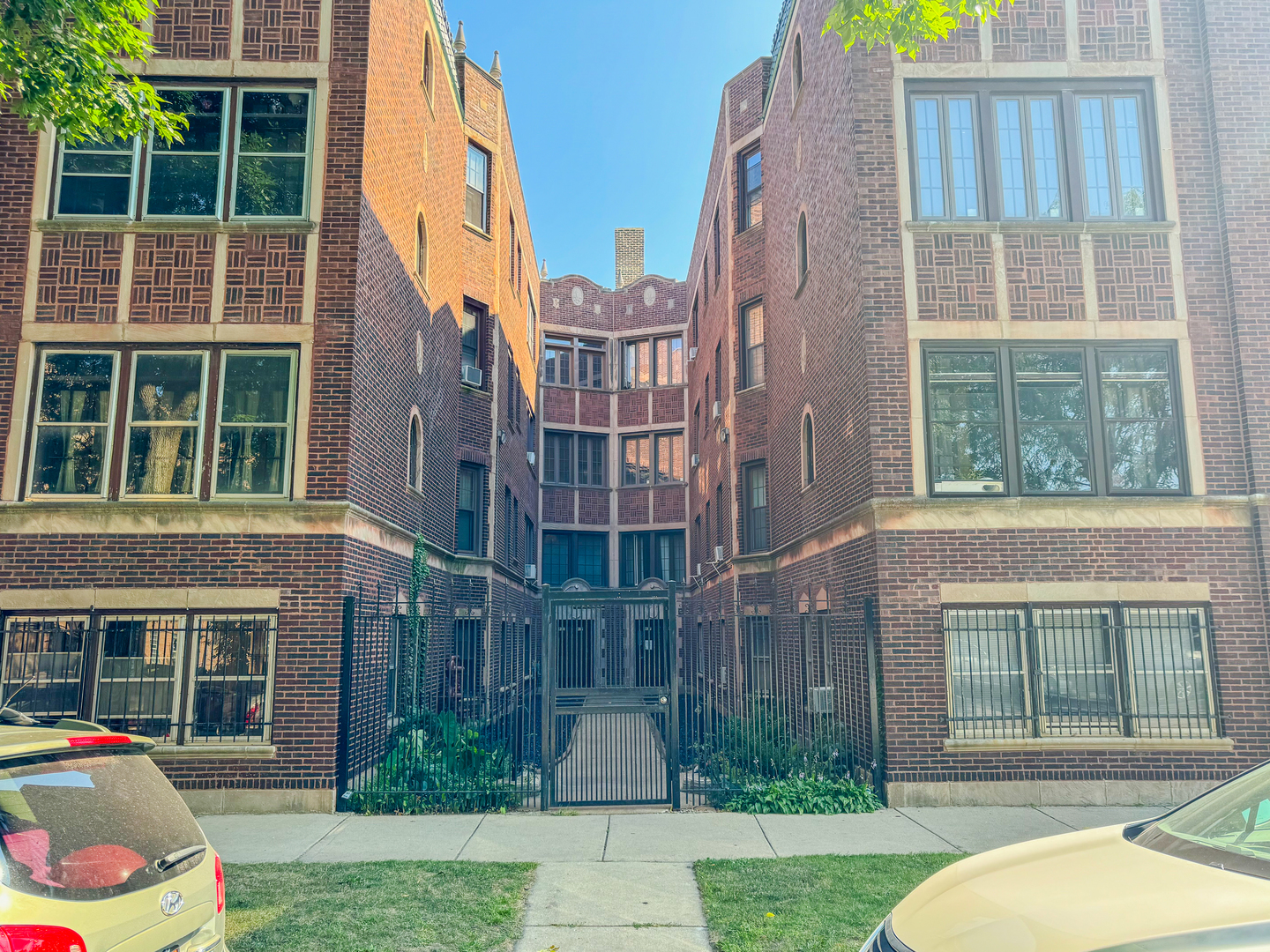 a view of a brick building next to a yard