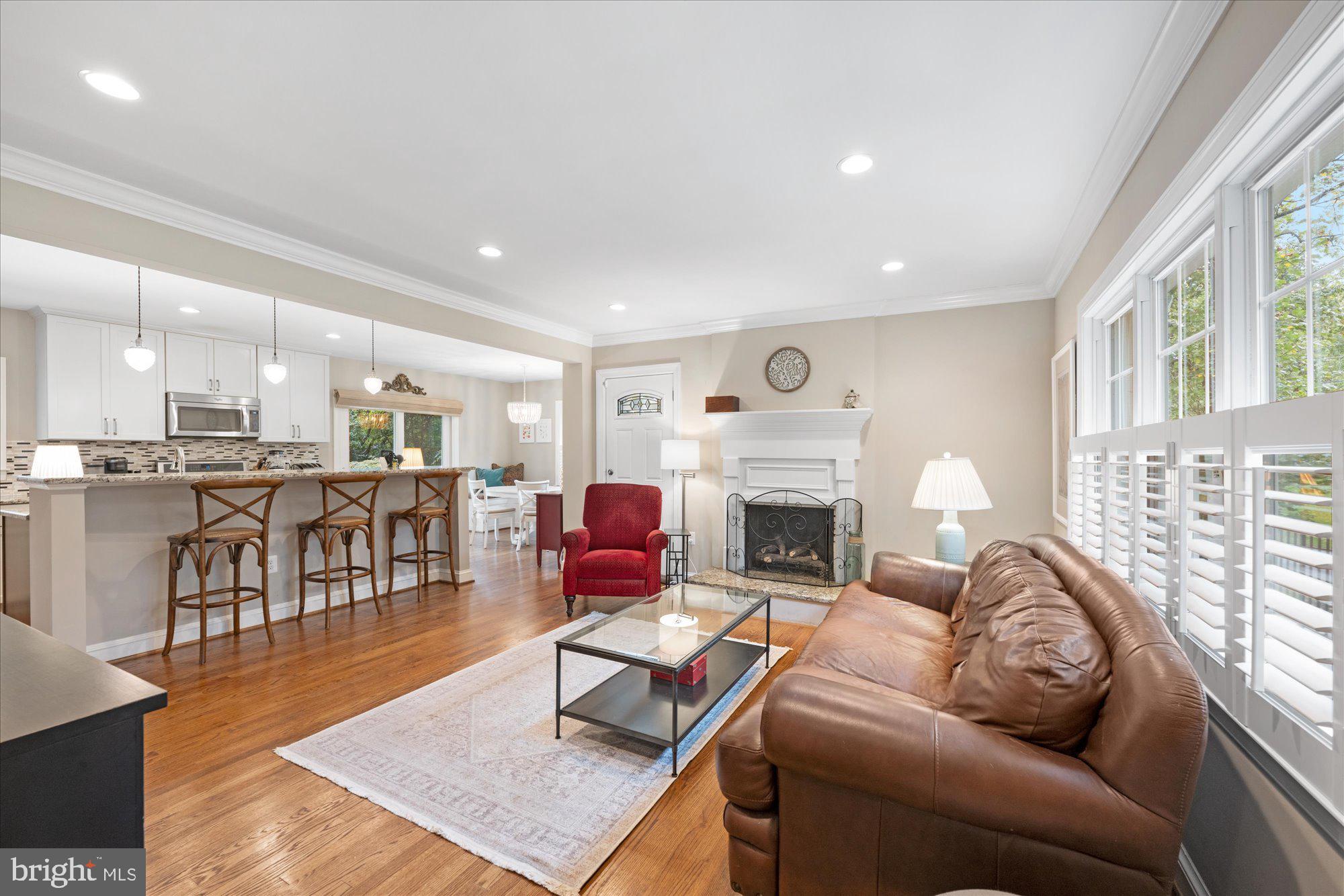 a living room with furniture wooden floor and a fireplace