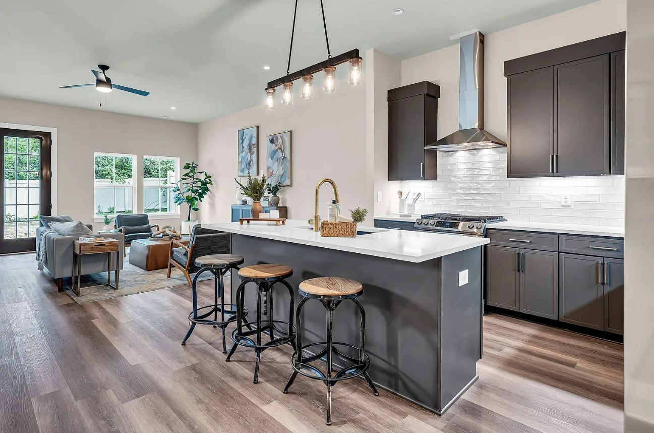 a kitchen with a sink cabinets and wooden floor