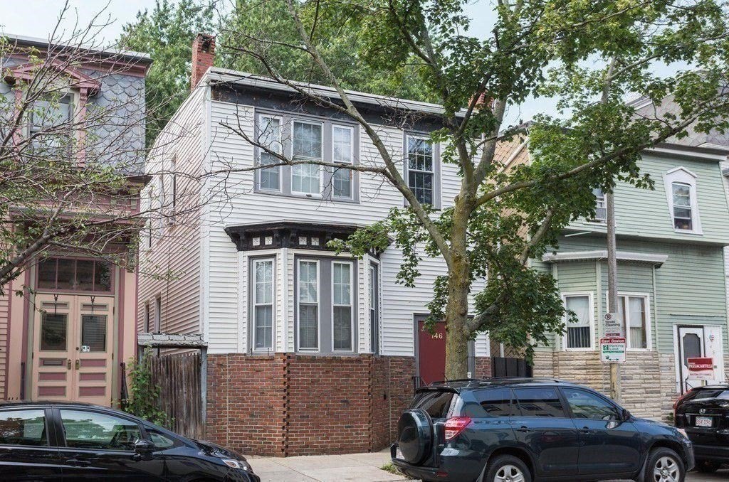 a view of a car parked in front of a house