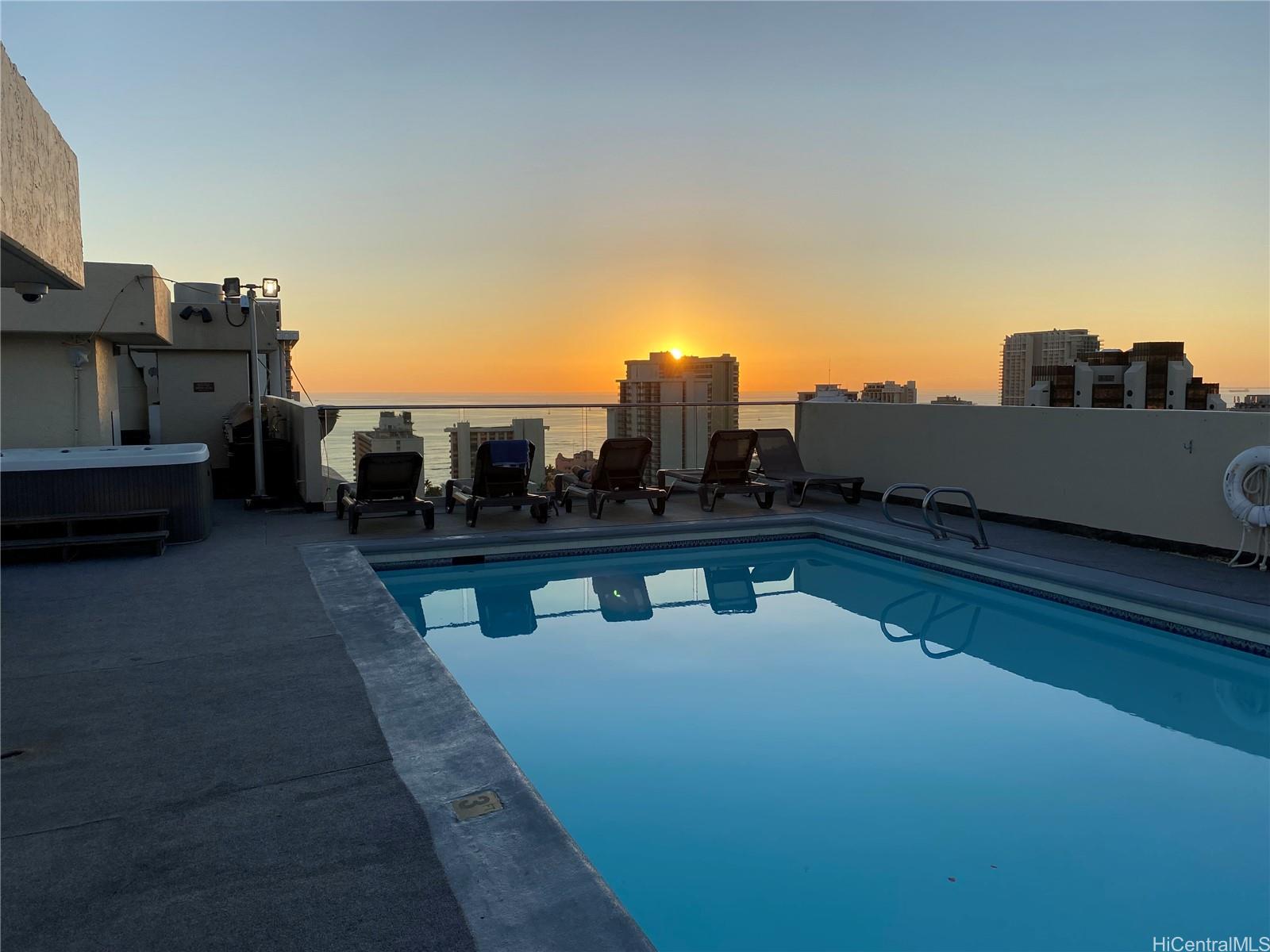 a view of swimming pool of water with outdoor seating