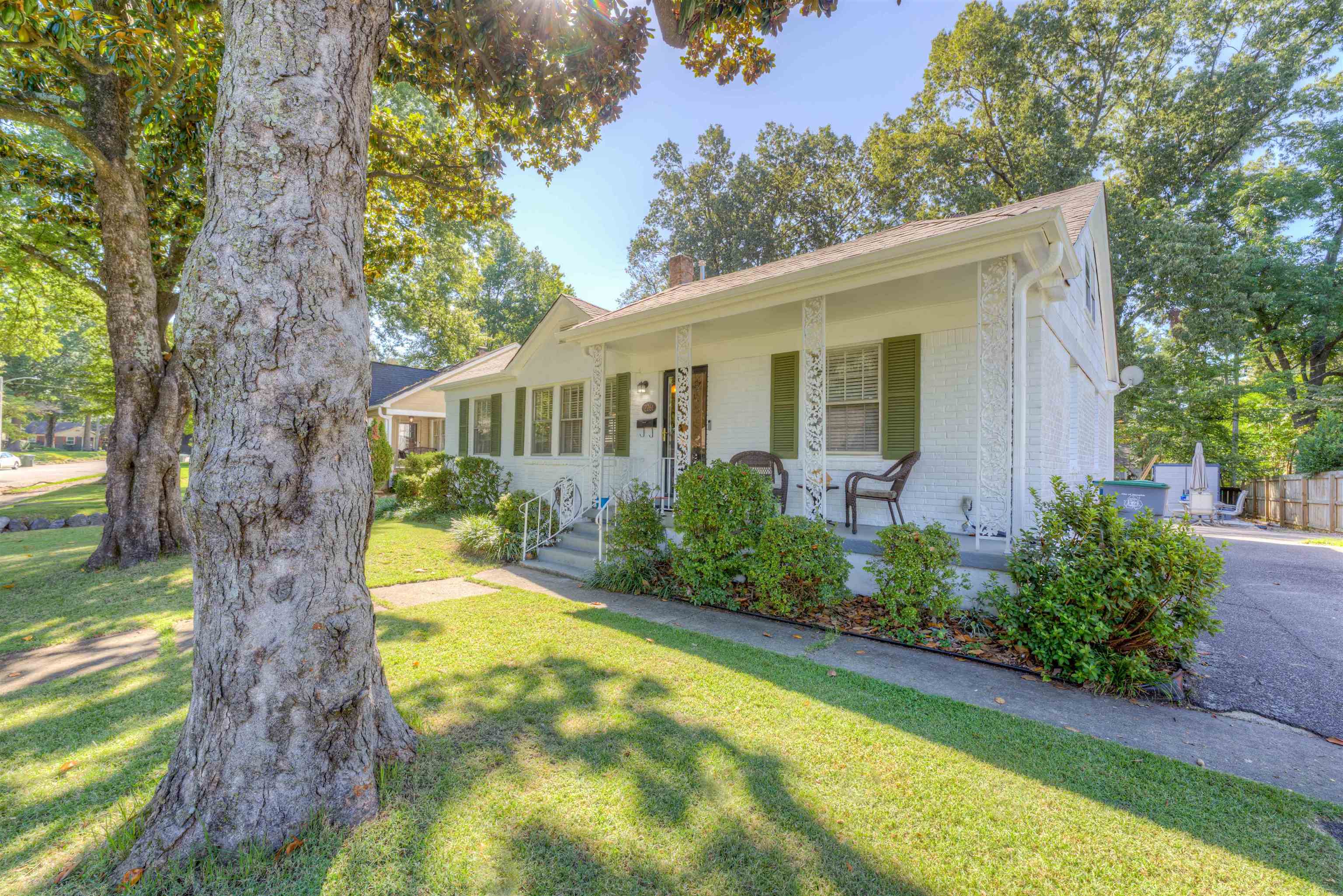 a view of a house with a yard patio and a garden