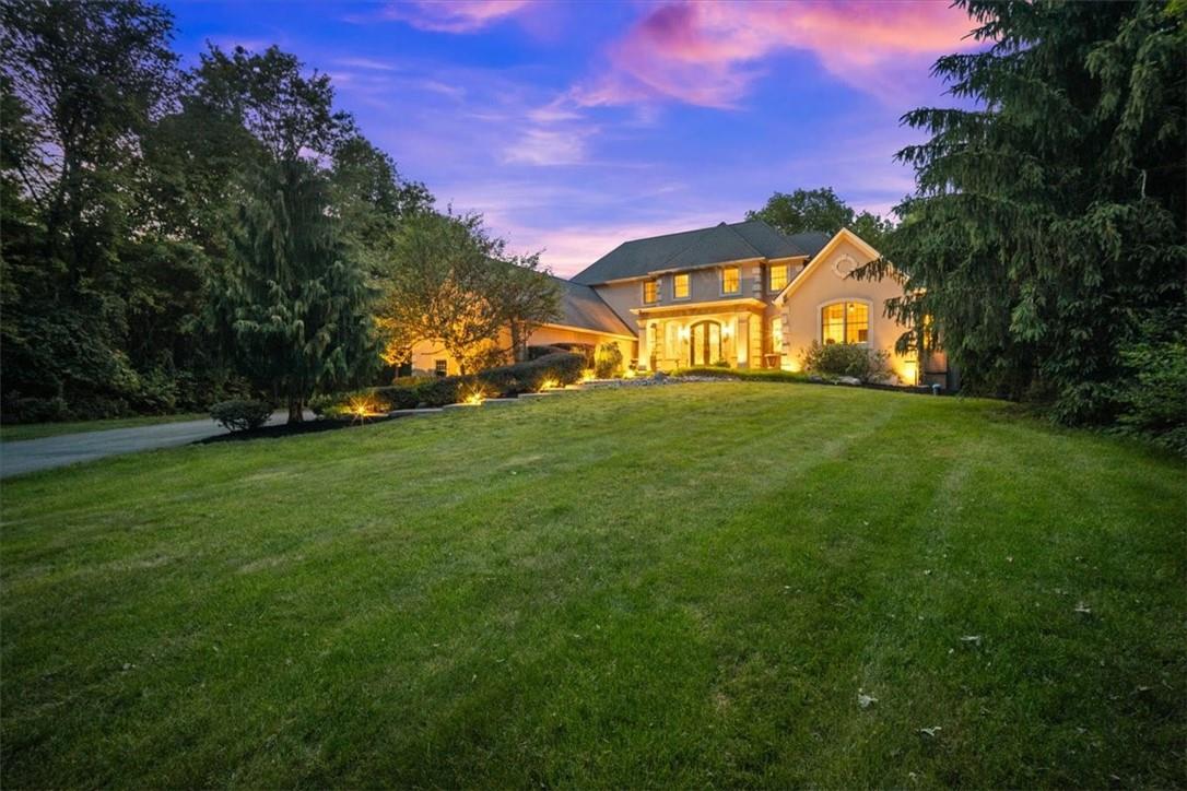 a view of a big yard with a house in the background