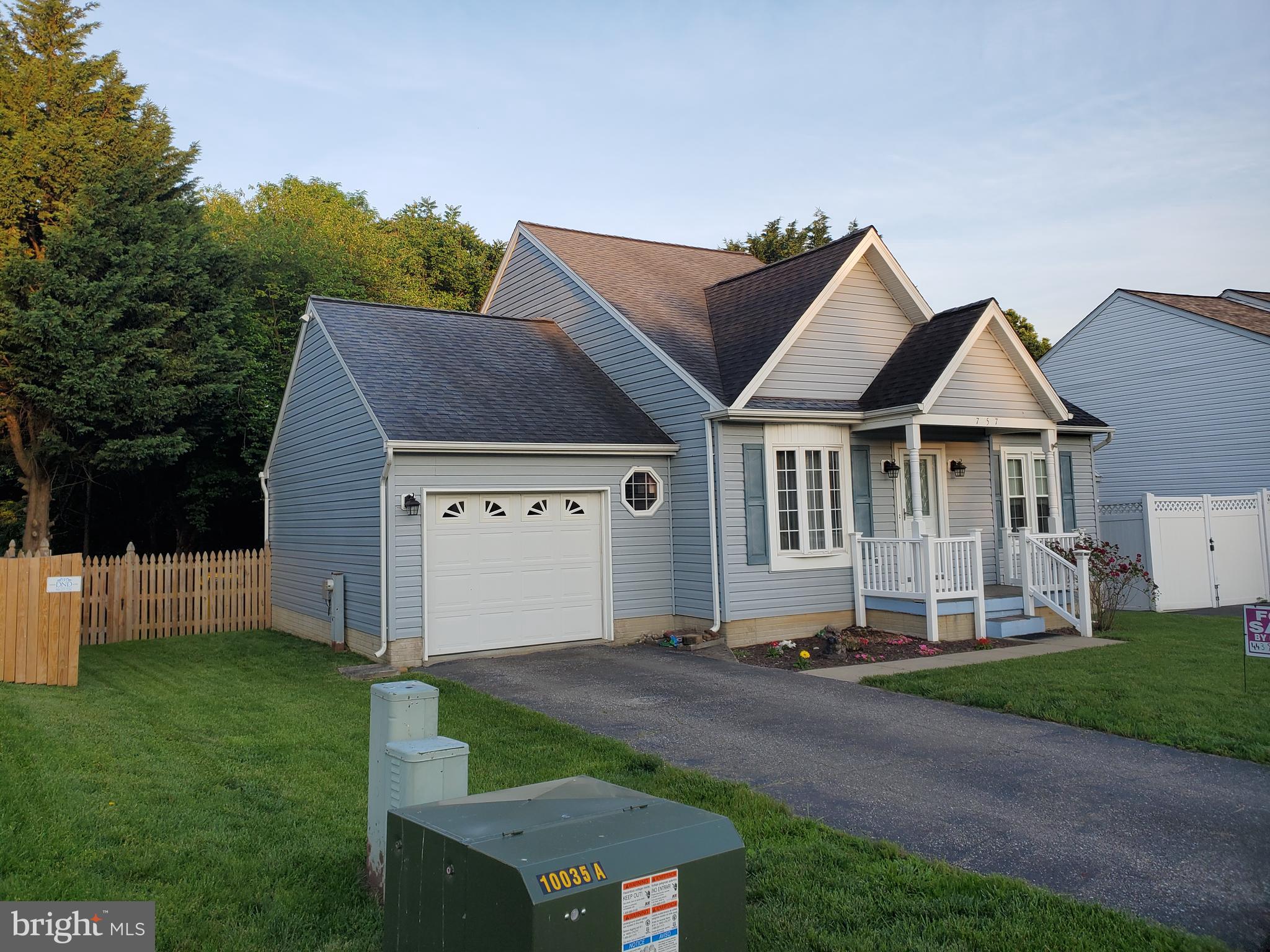 a house with green field in front of it