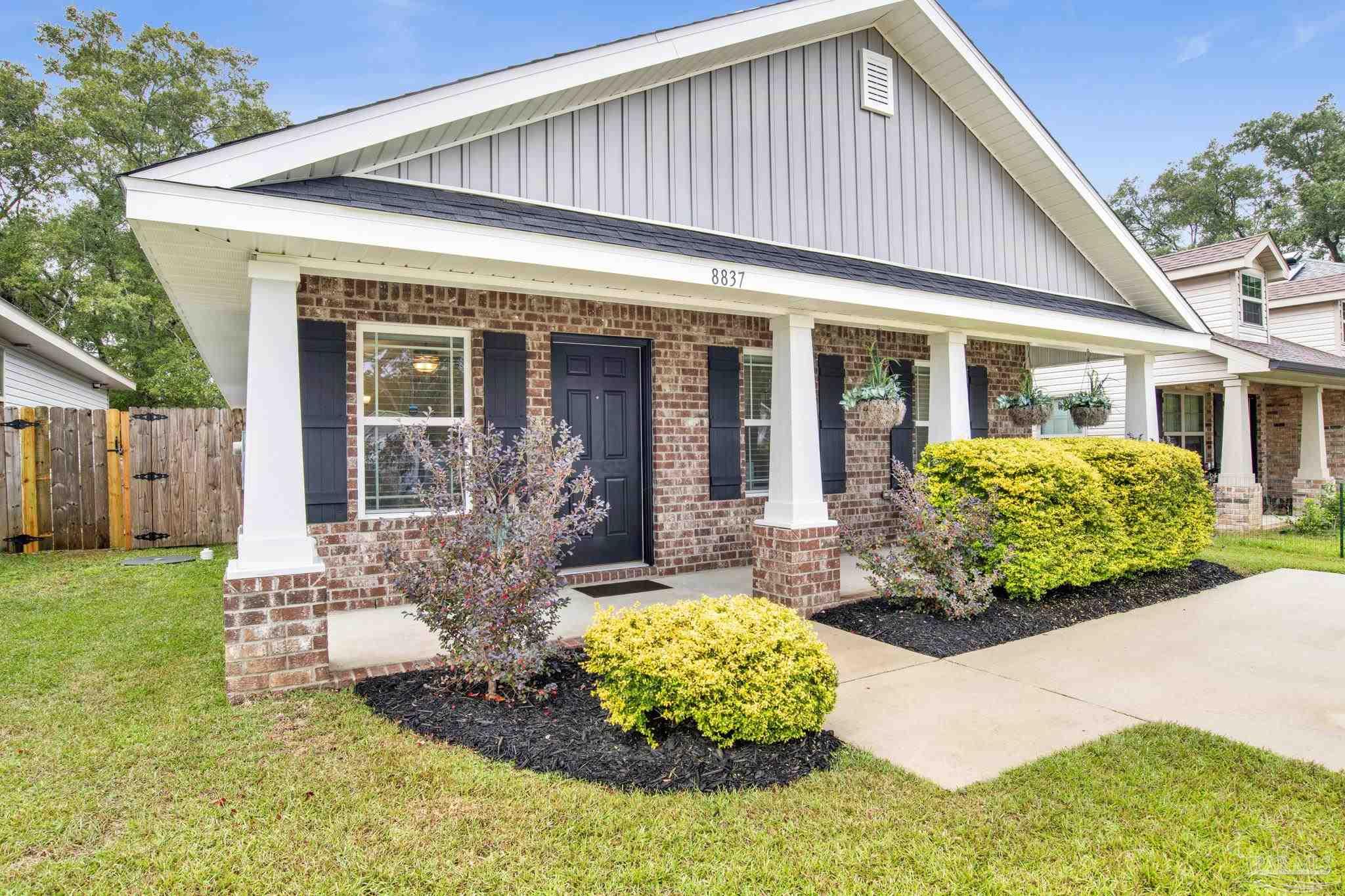 a front view of a house with garden