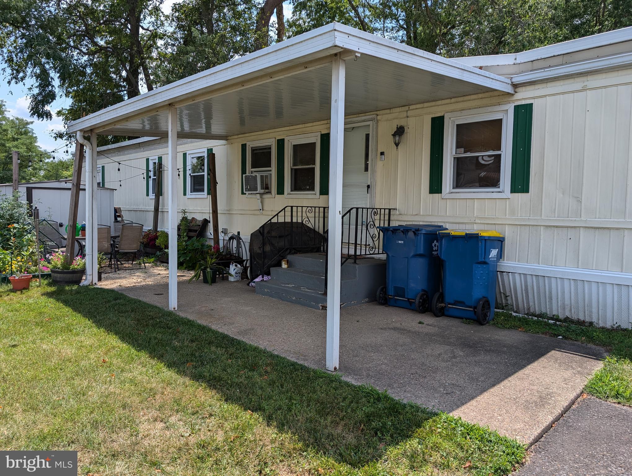 a view of a house with backyard and sitting area