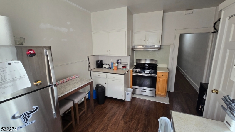 a kitchen with a refrigerator and a stove