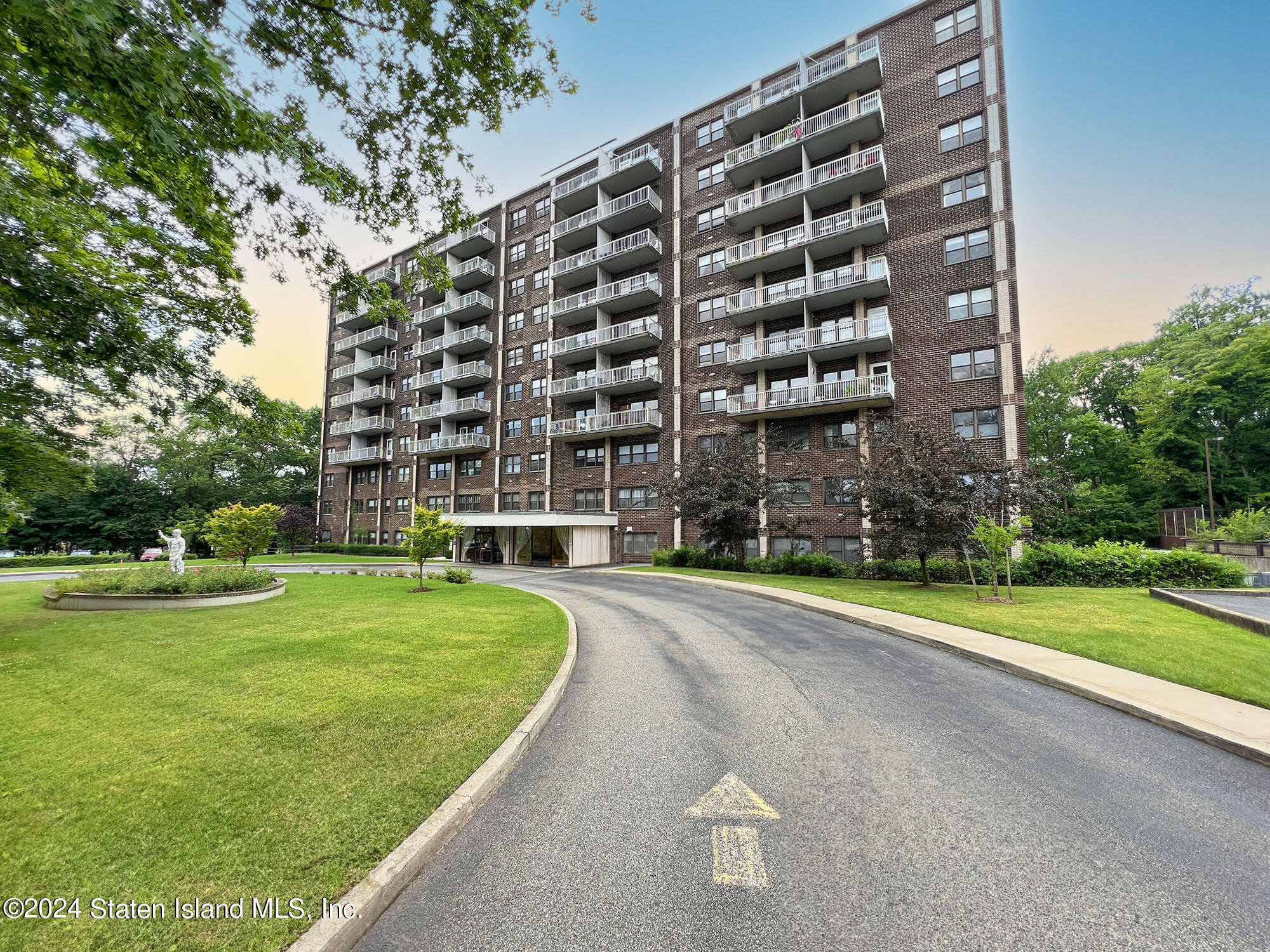 a view of a tall building next to a big yard