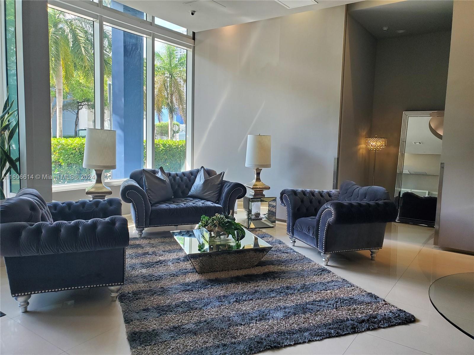 a living room with furniture windows and a table