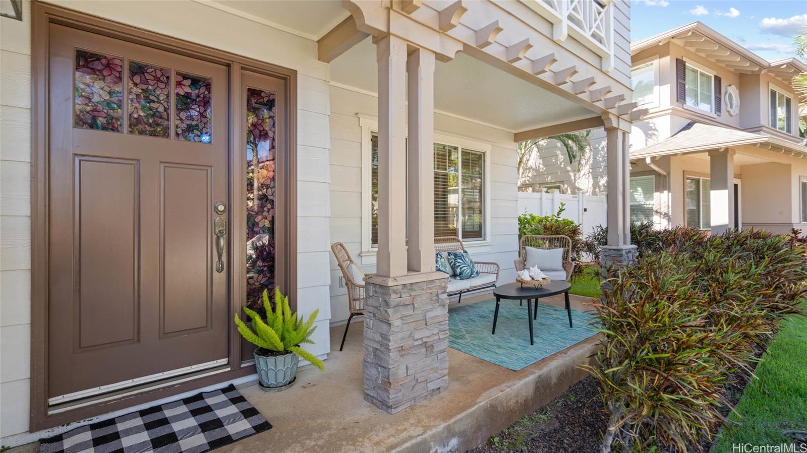 a view of a porch with chairs and potted plants