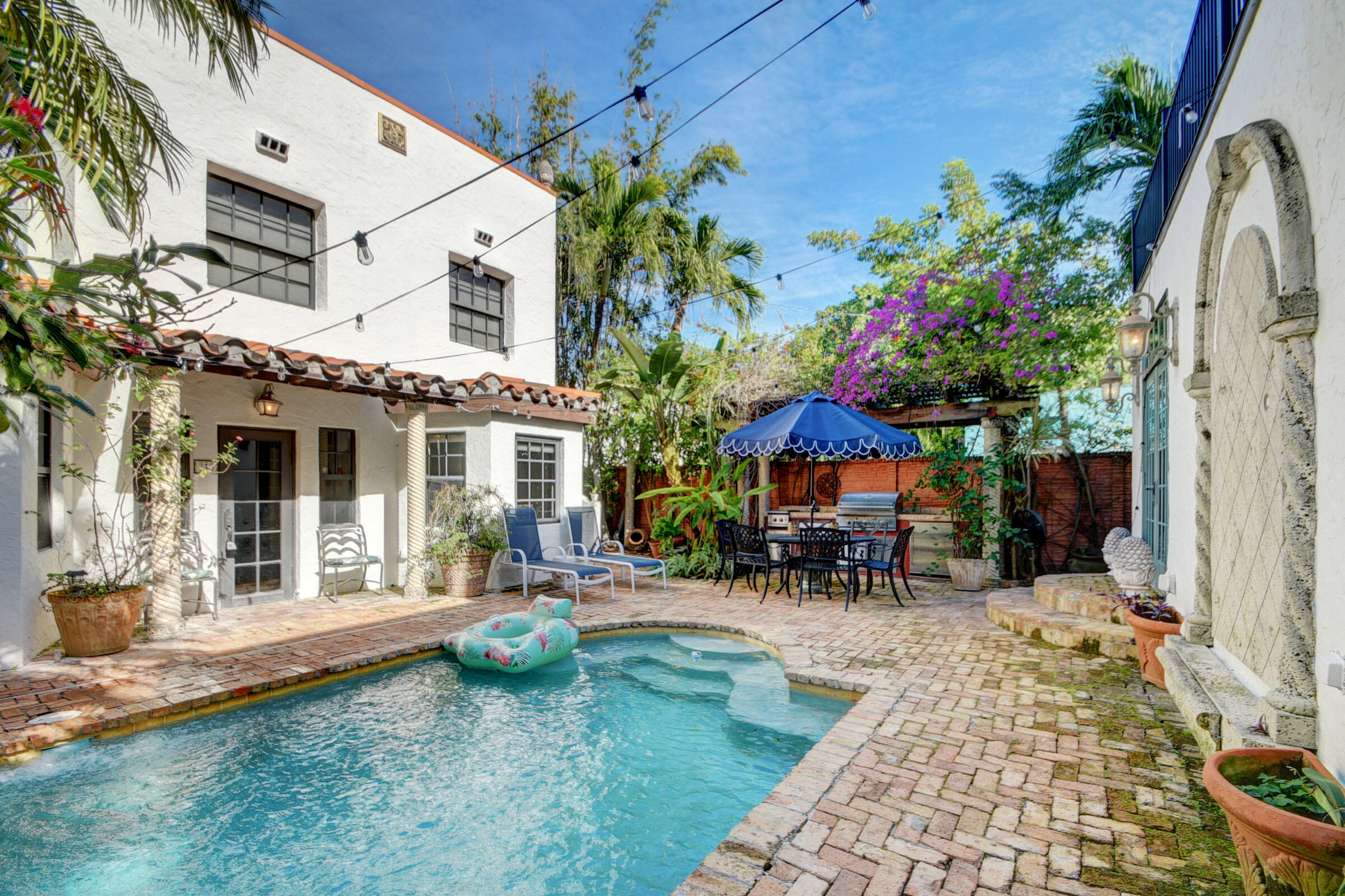 a view of a house with backyard porch and sitting area