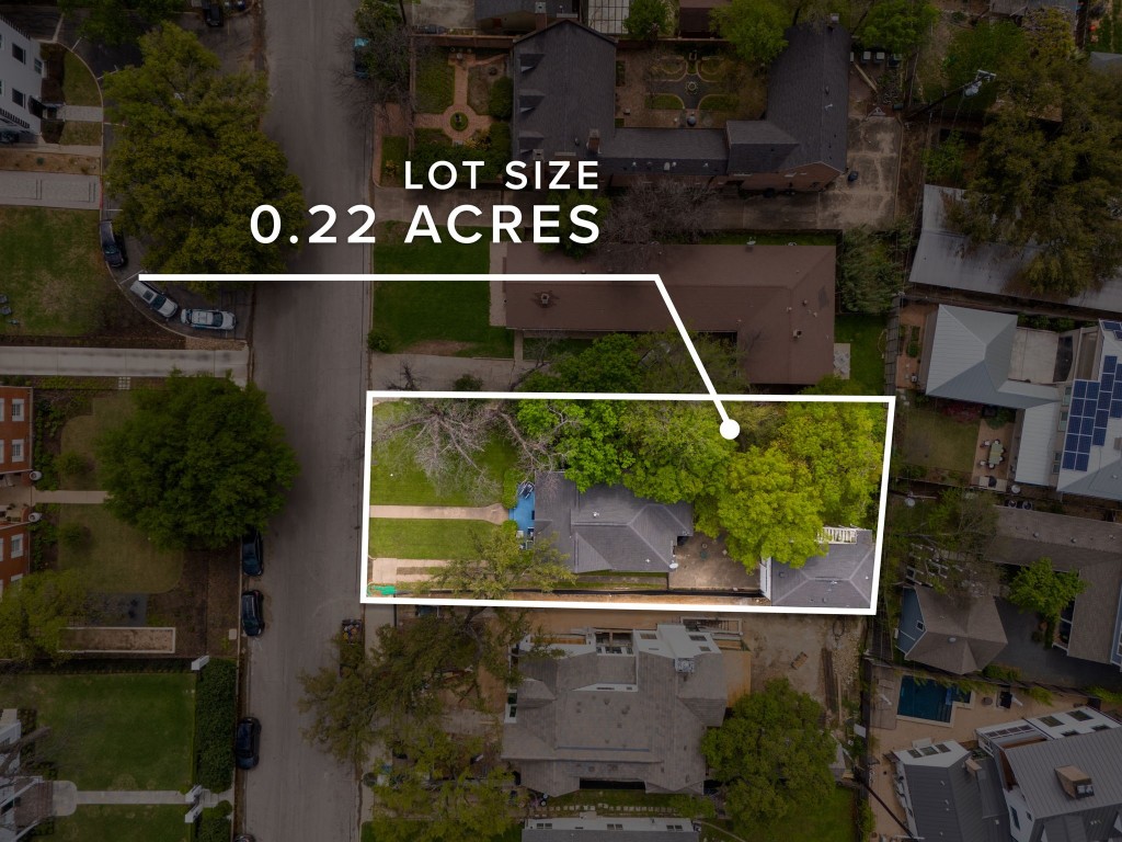 an aerial view of a wooden house with a yard