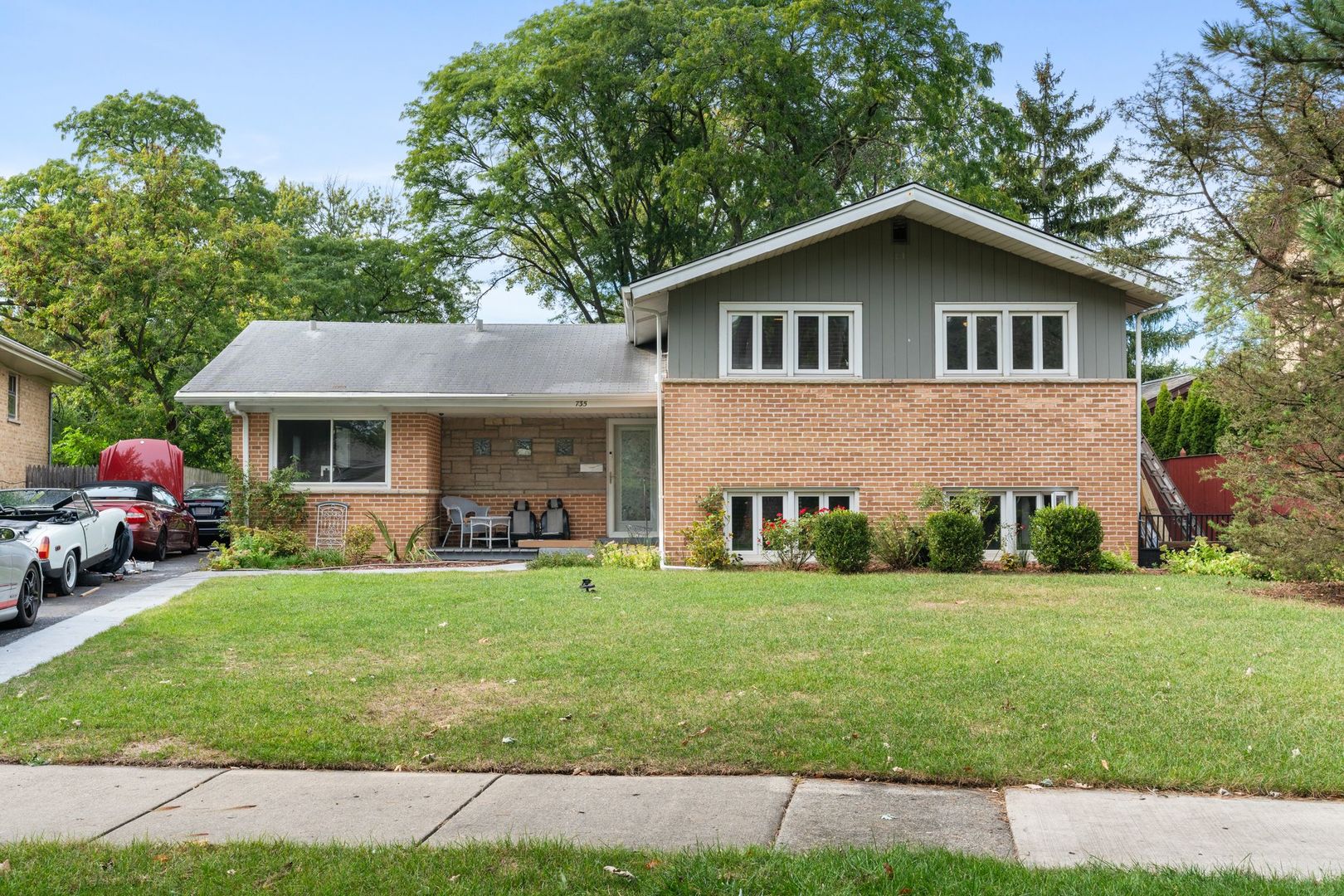 a front view of house with yard and green space