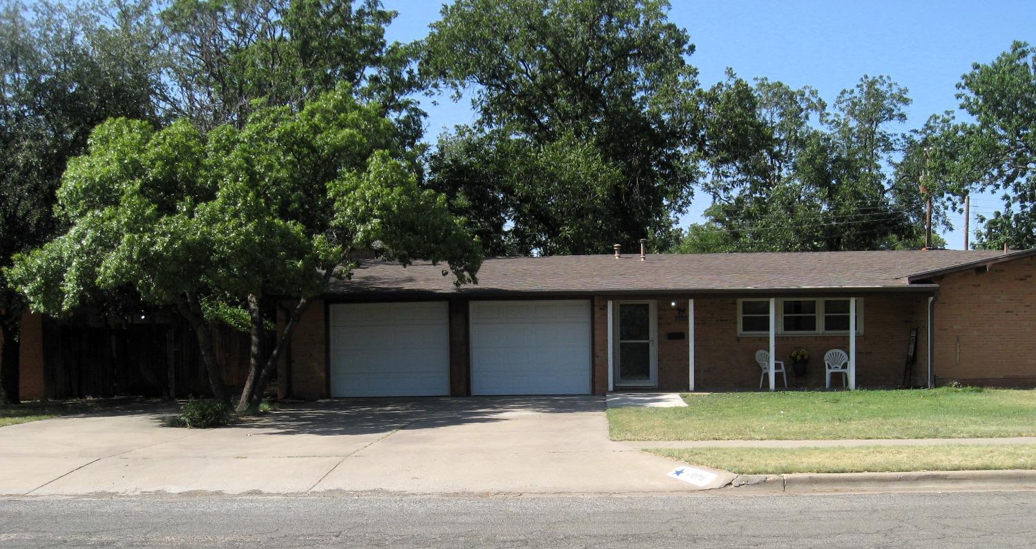 a house with a tree in front of it