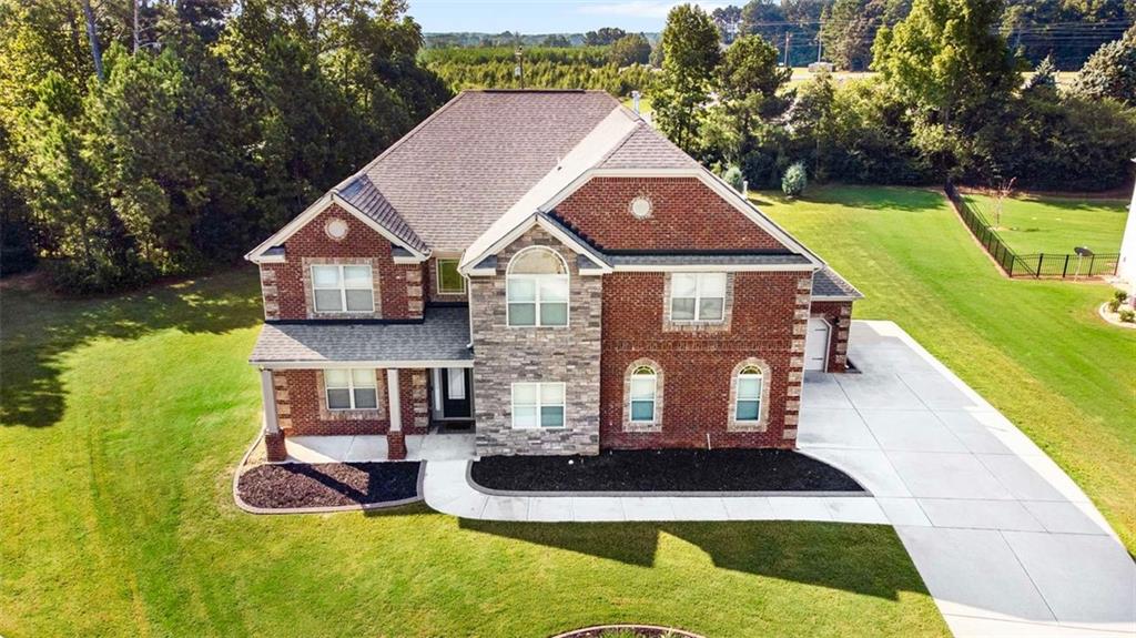 a aerial view of a house with swimming pool and a yard