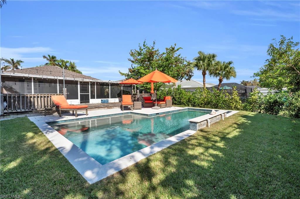 swimming pool view with a seating space