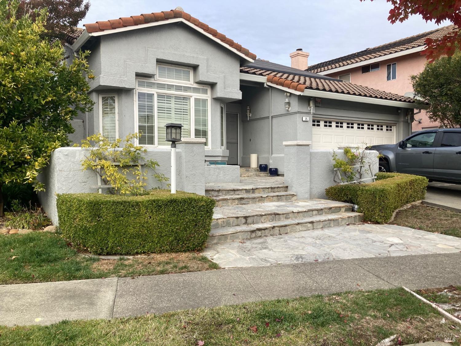 a front view of a house with a garden