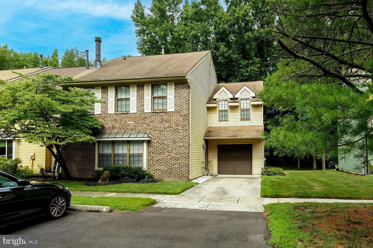 a front view of a house with a garden and yard