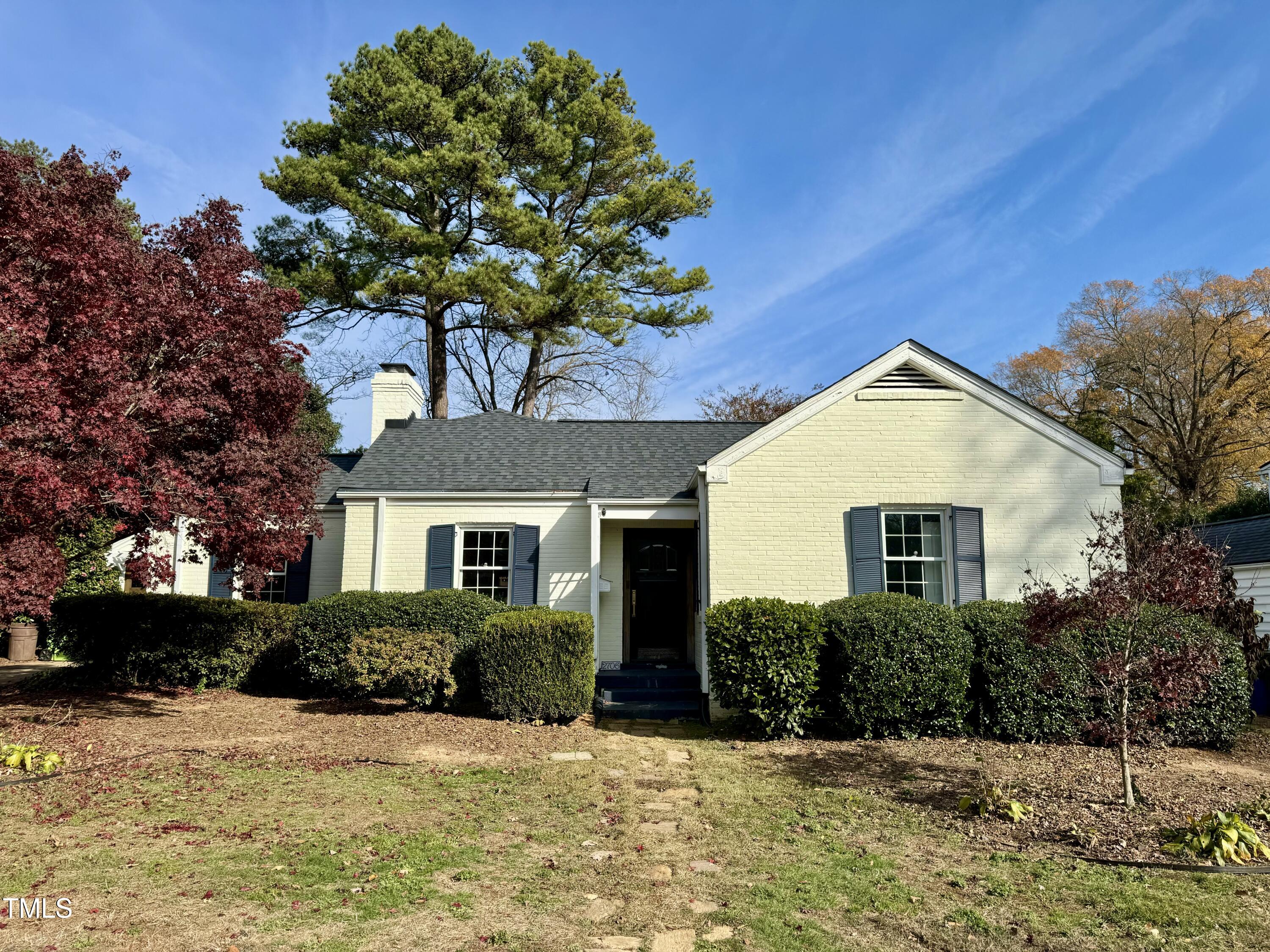 a house that has a tree in front of it