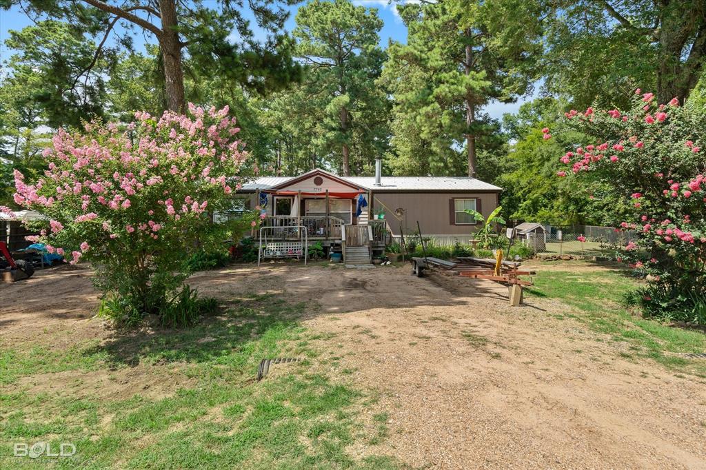 a view of a house with a yard and sitting area