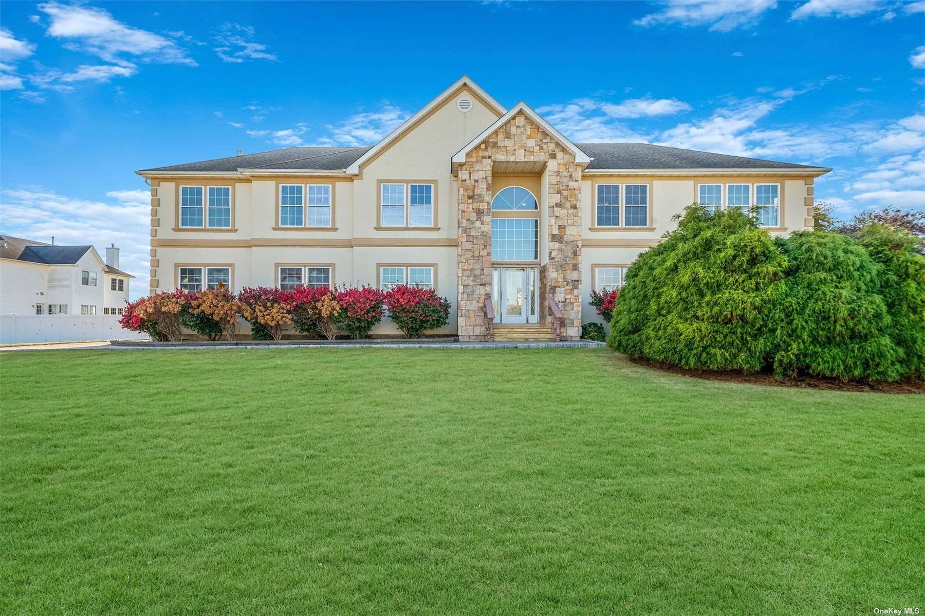 a front view of a house with a garden