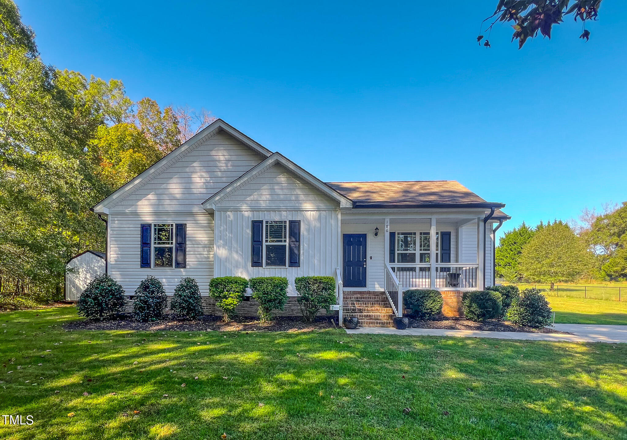 a front view of house with yard and green space