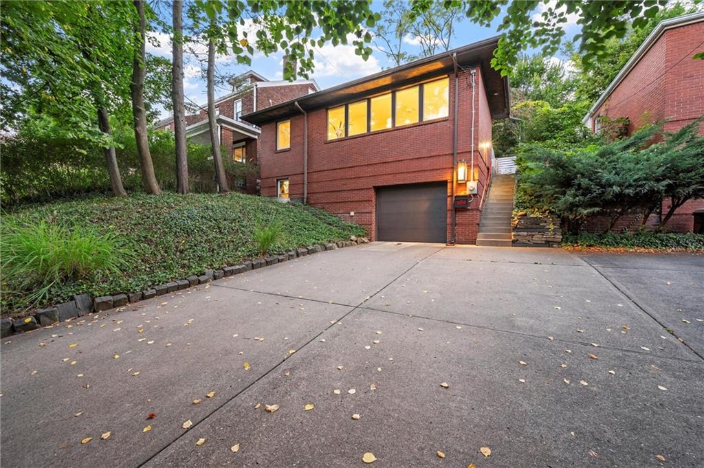 a front view of a house with a yard and a garage