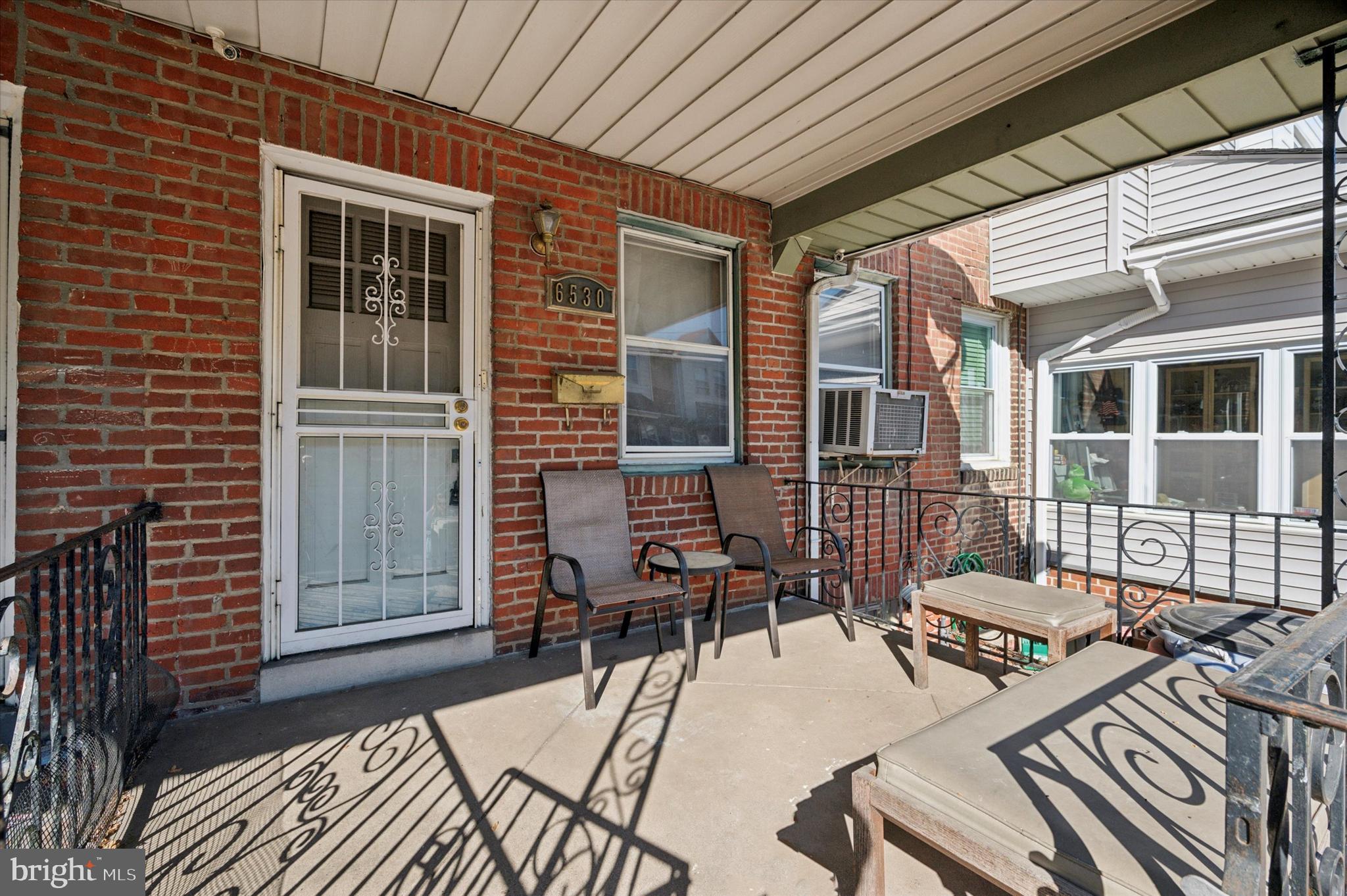 a view of a patio with chairs and potted plants